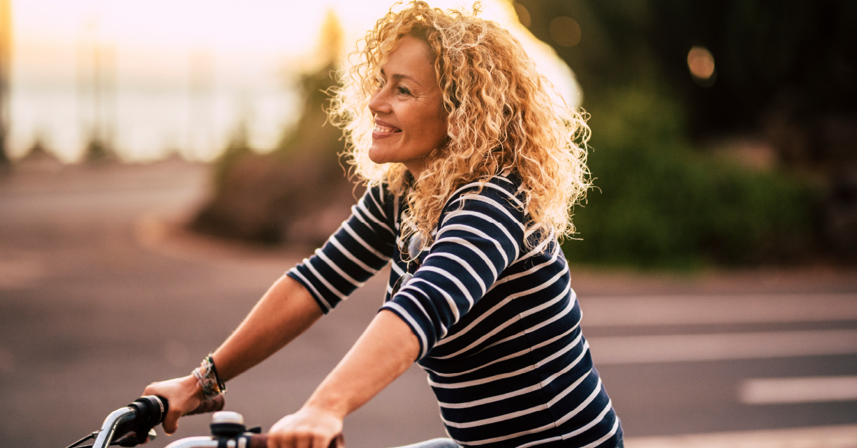 woman-with-blonde-hair-riding-bicycle